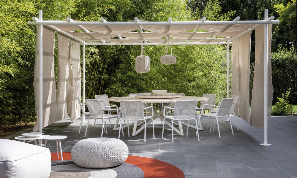 esempio di arredi da esterno in pietra naturale con tavolo da giardino dal top in travertino