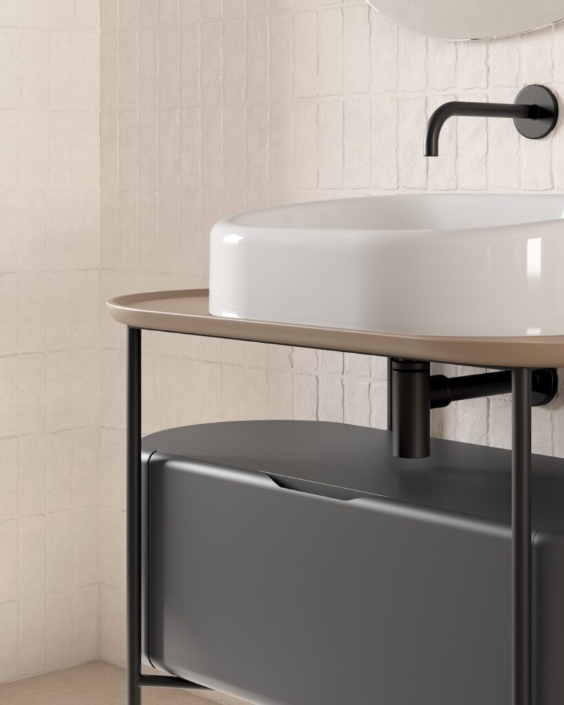 Acciaio e ceramica si incontrano in un sistema bagno integrato dalla linea essenziale